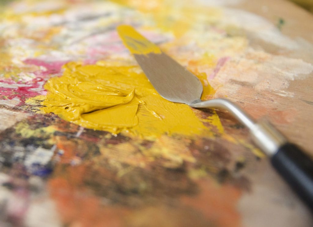 yellow ochre oil paint and water mixed on the palette
